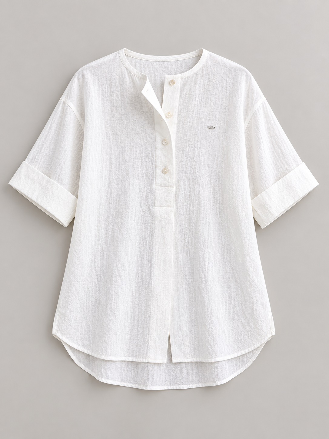 White cotton Henley popover with back pleat, flat lay front.