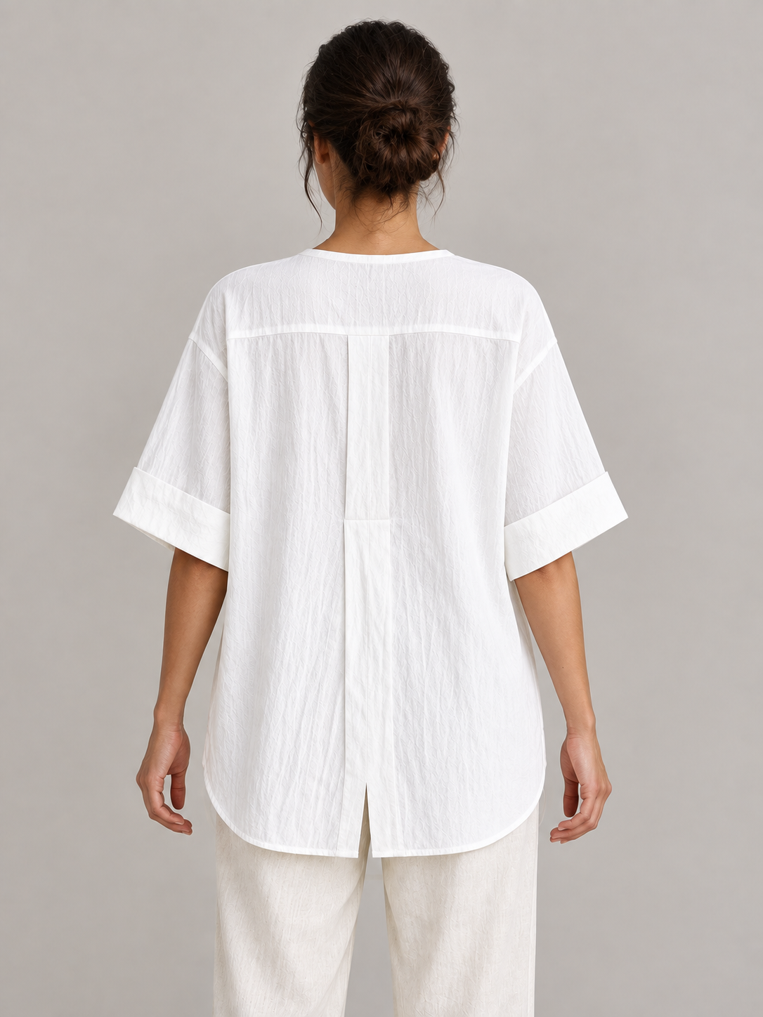 White cotton Henley popover with back pleat, model back.