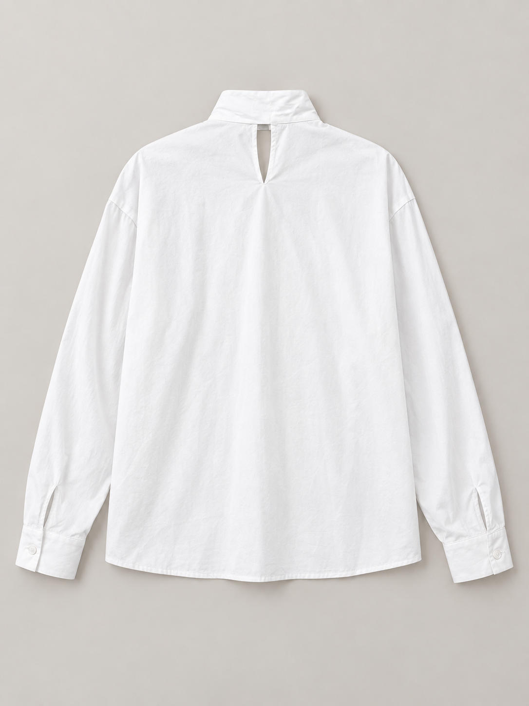 White cotton tie-neck blouse, flat lay back.