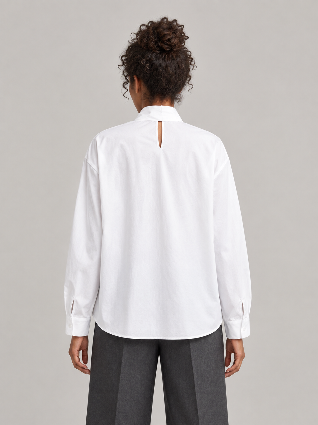 White cotton tie-neck blouse, model back.