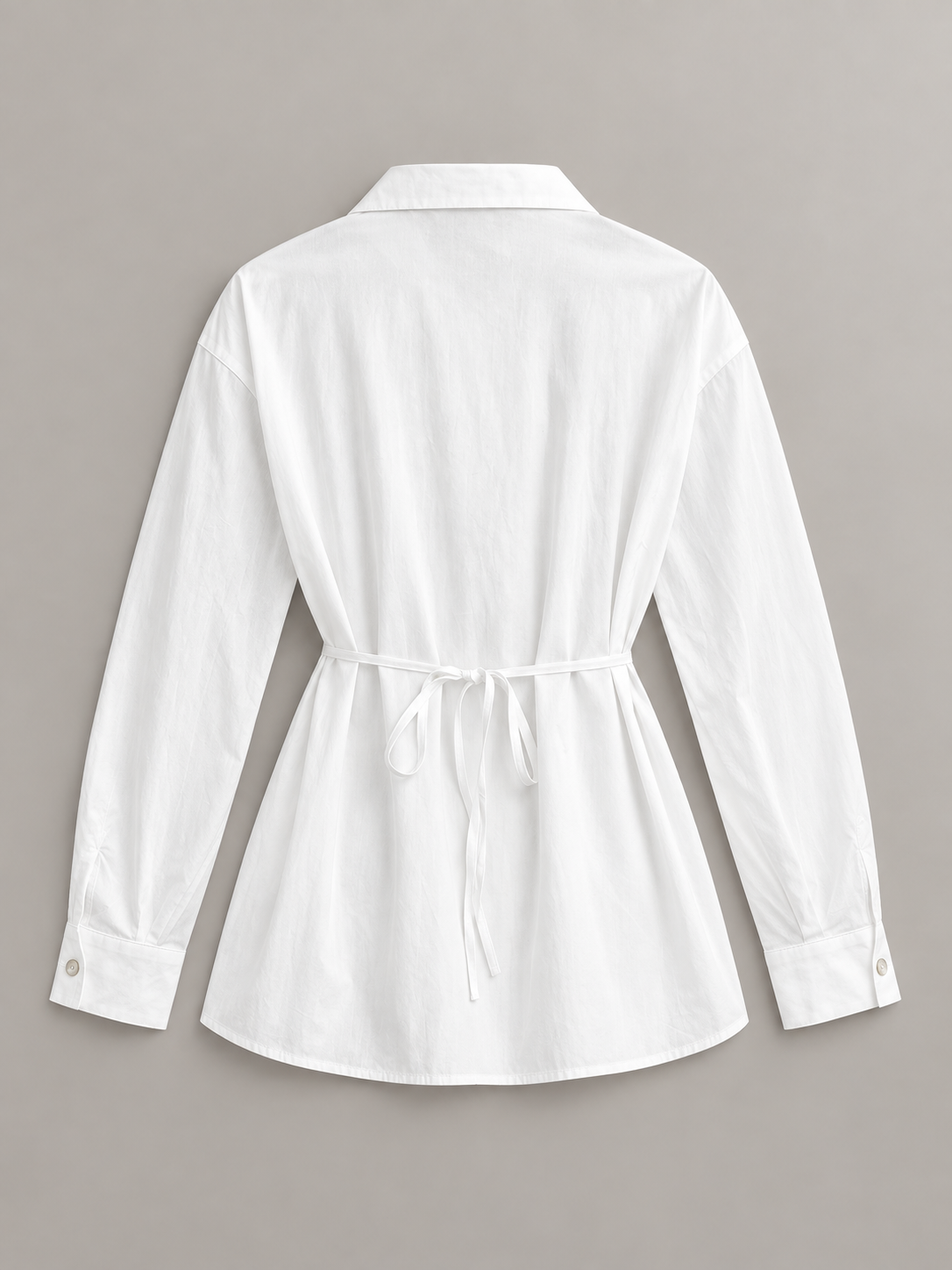 White tie-neck button-front shirt, flat lay back.