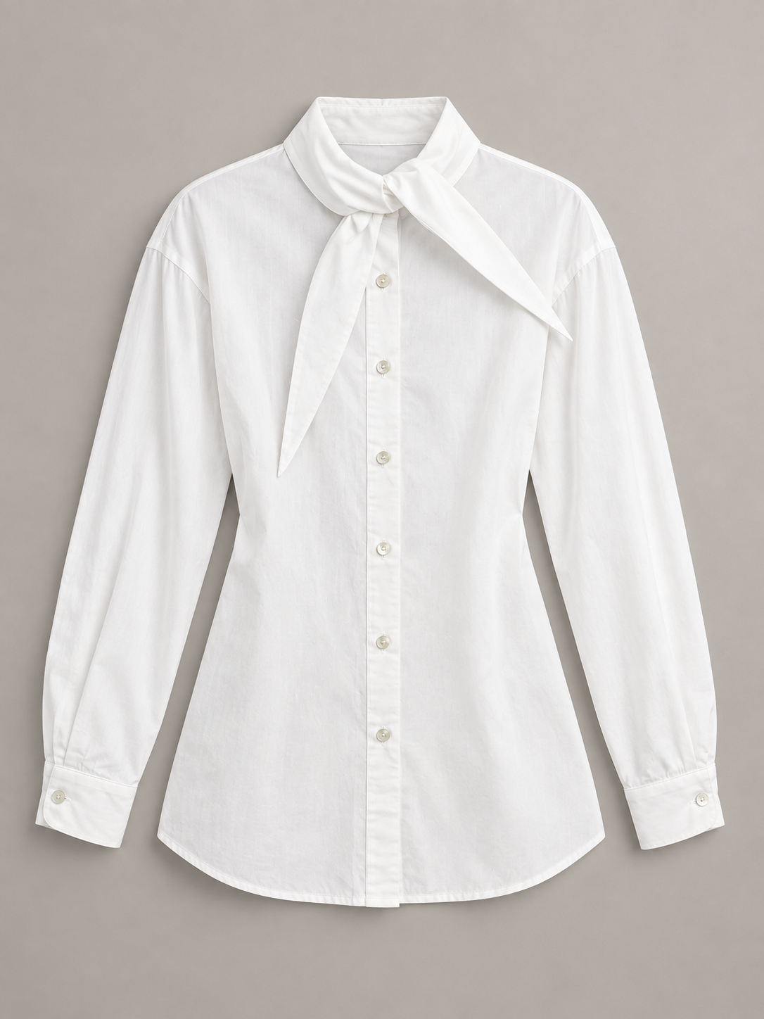 White tie-neck button-front shirt, flat lay front.