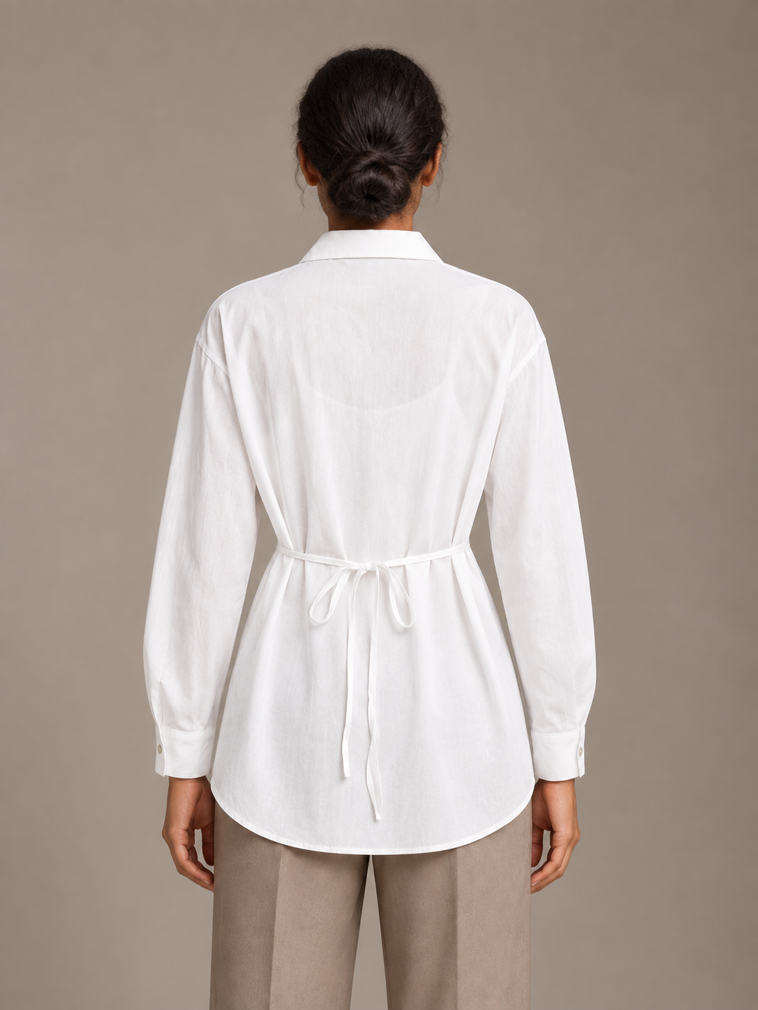 White tie-neck button-front shirt, model back.
