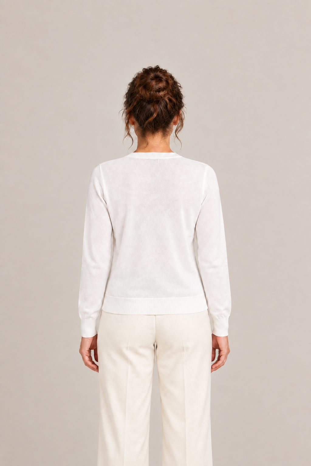 White regular cotton V-neck cardigan on a model, back view.