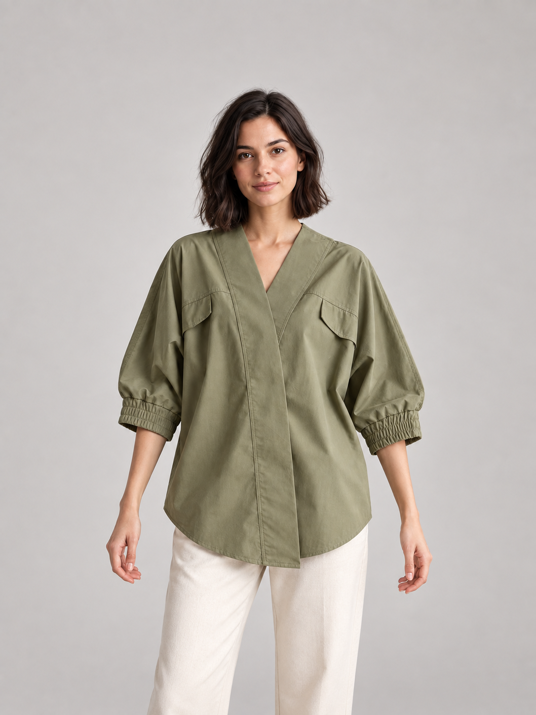 Olive Green wrap-effect batwing blouse, model front.