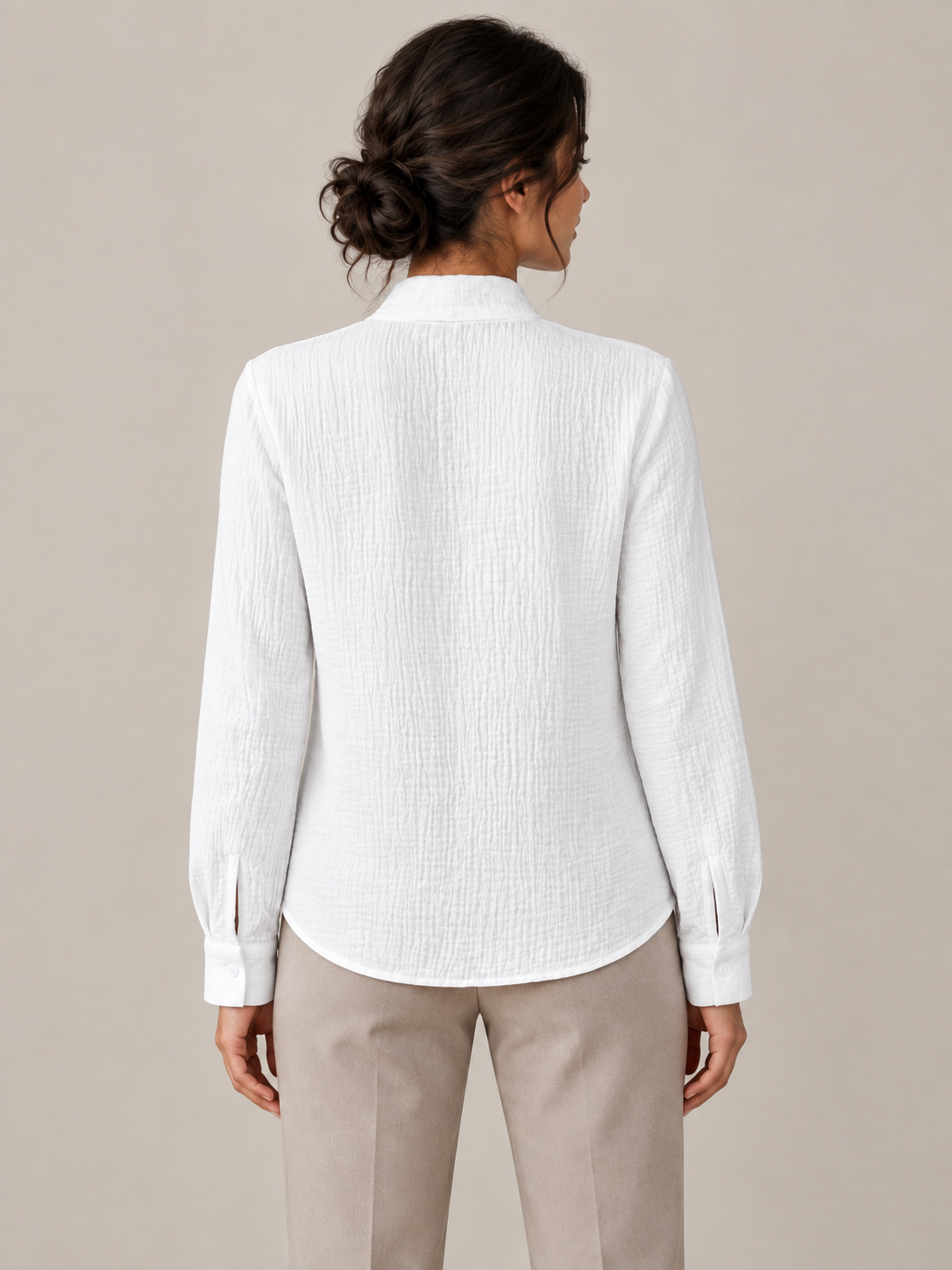 White crinkled cotton blouse with scarf neck ties, model back.