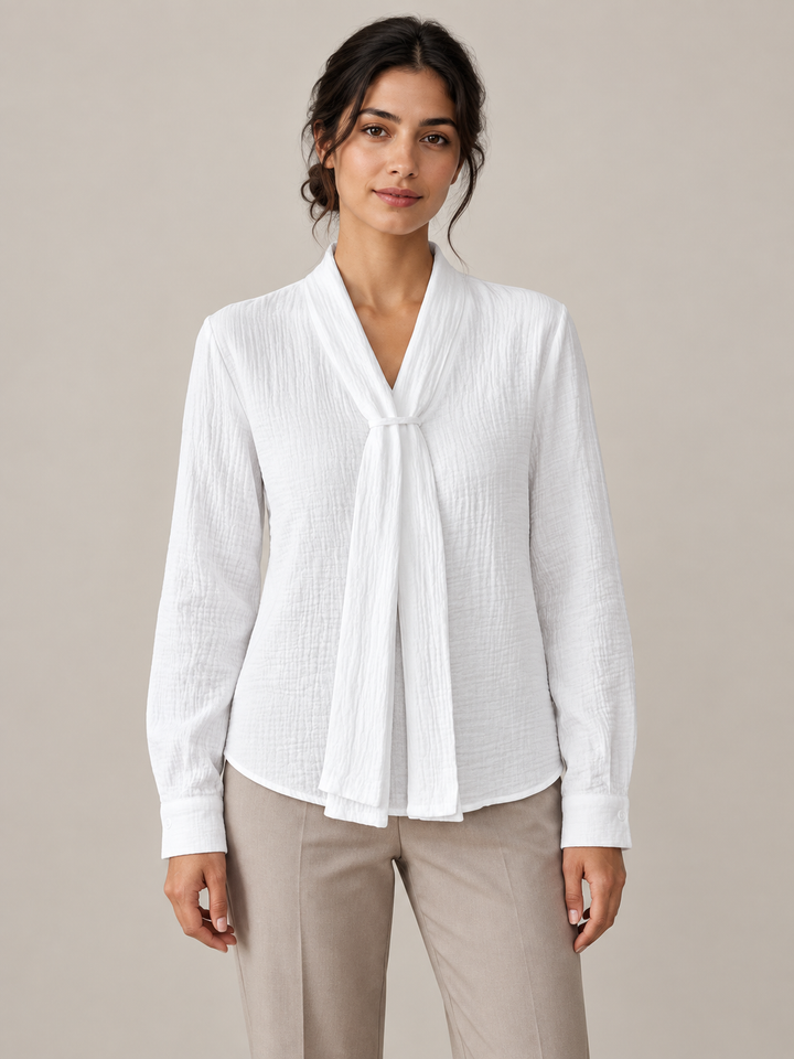 White crinkled cotton blouse with scarf neck ties, model front.