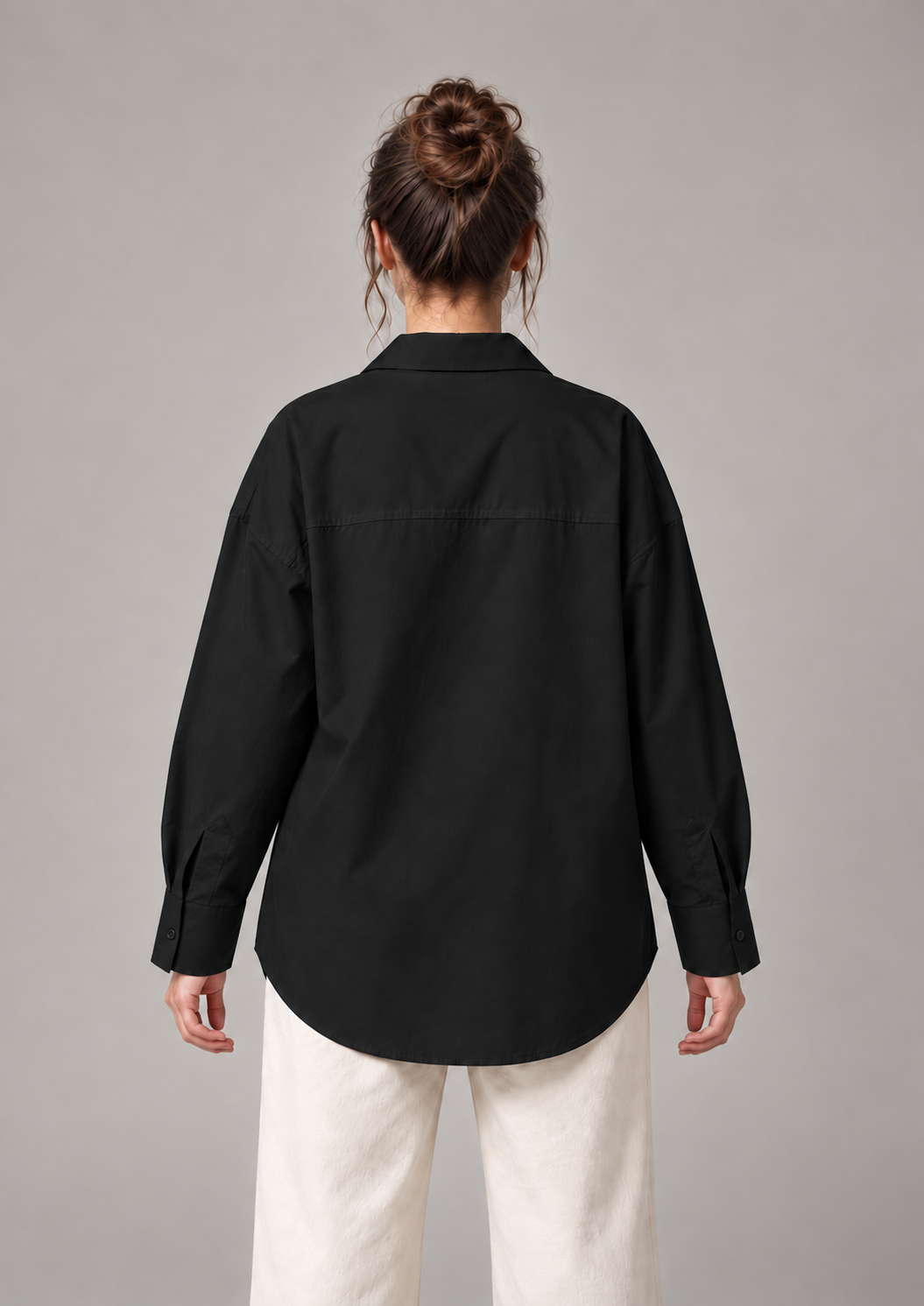 Black oversized button-up shirt, back on an original model showing the plain back panel.