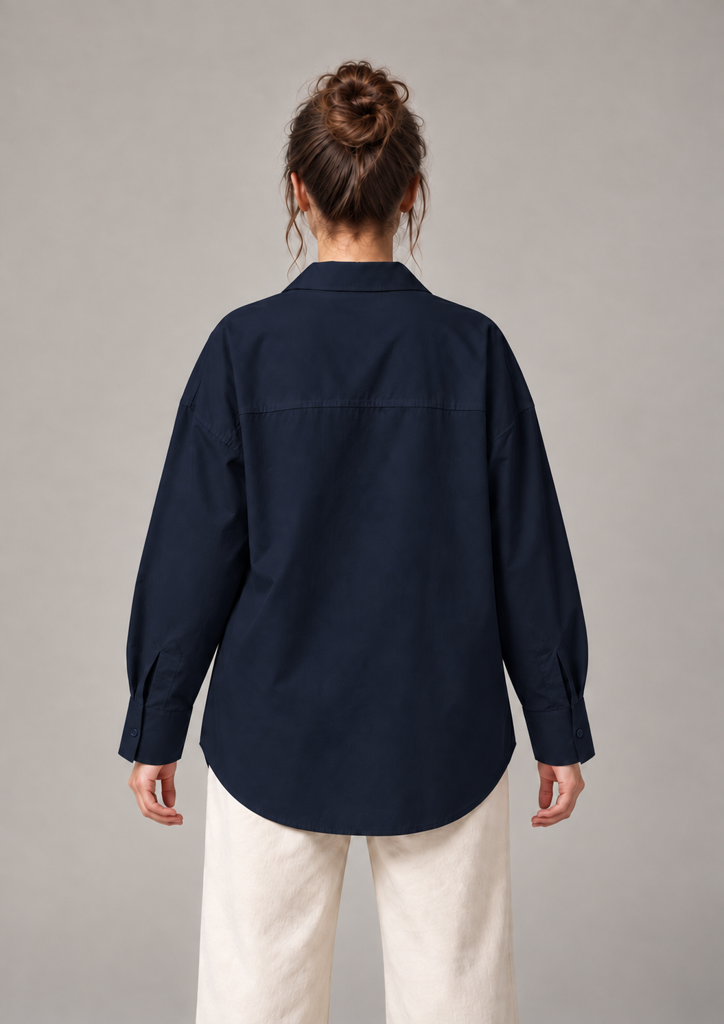 Navy blue oversized button-up shirt, back on an original model showing the plain back panel.