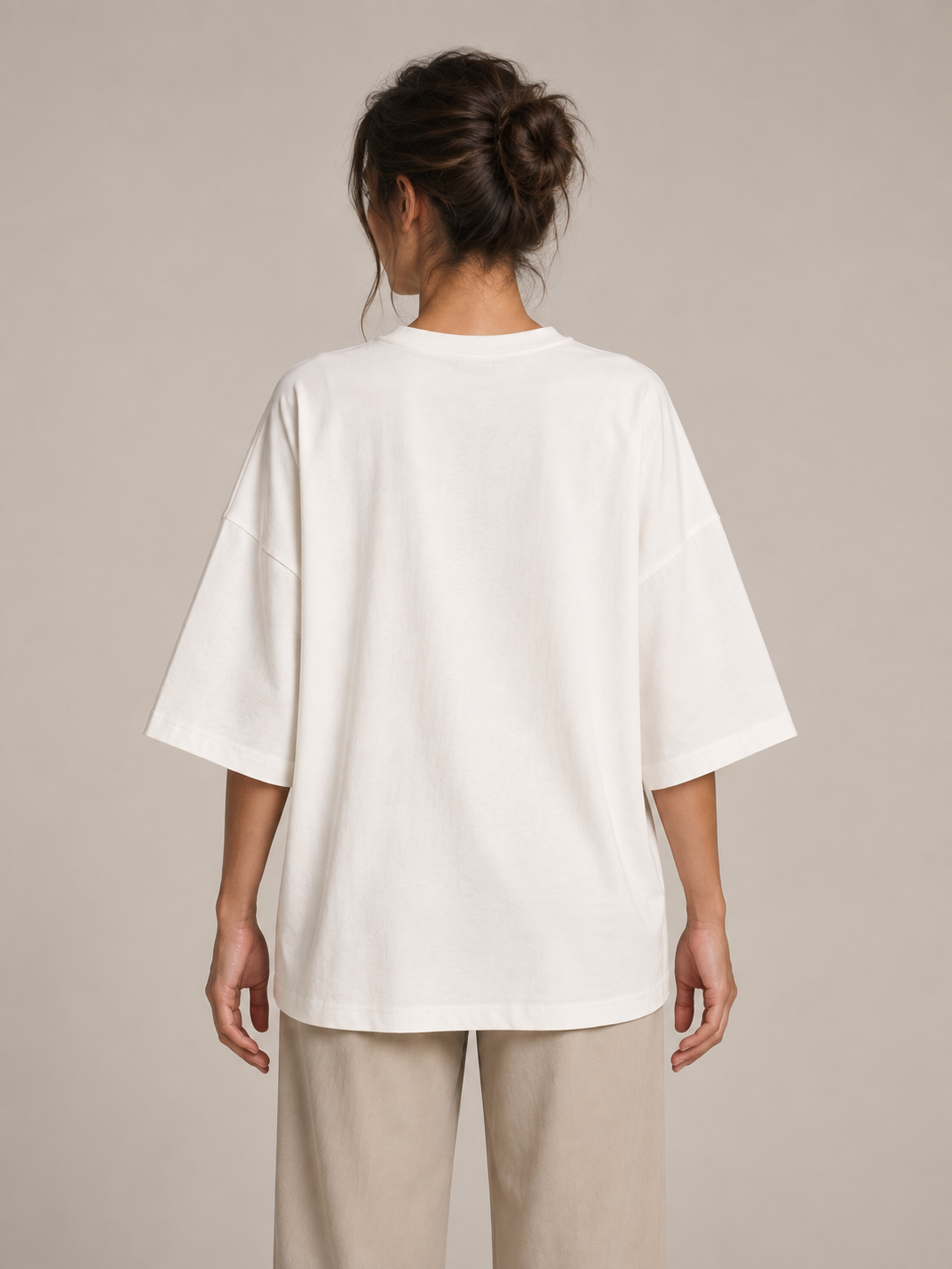White oversized cotton half-sleeve T-shirt, rear view on a model.