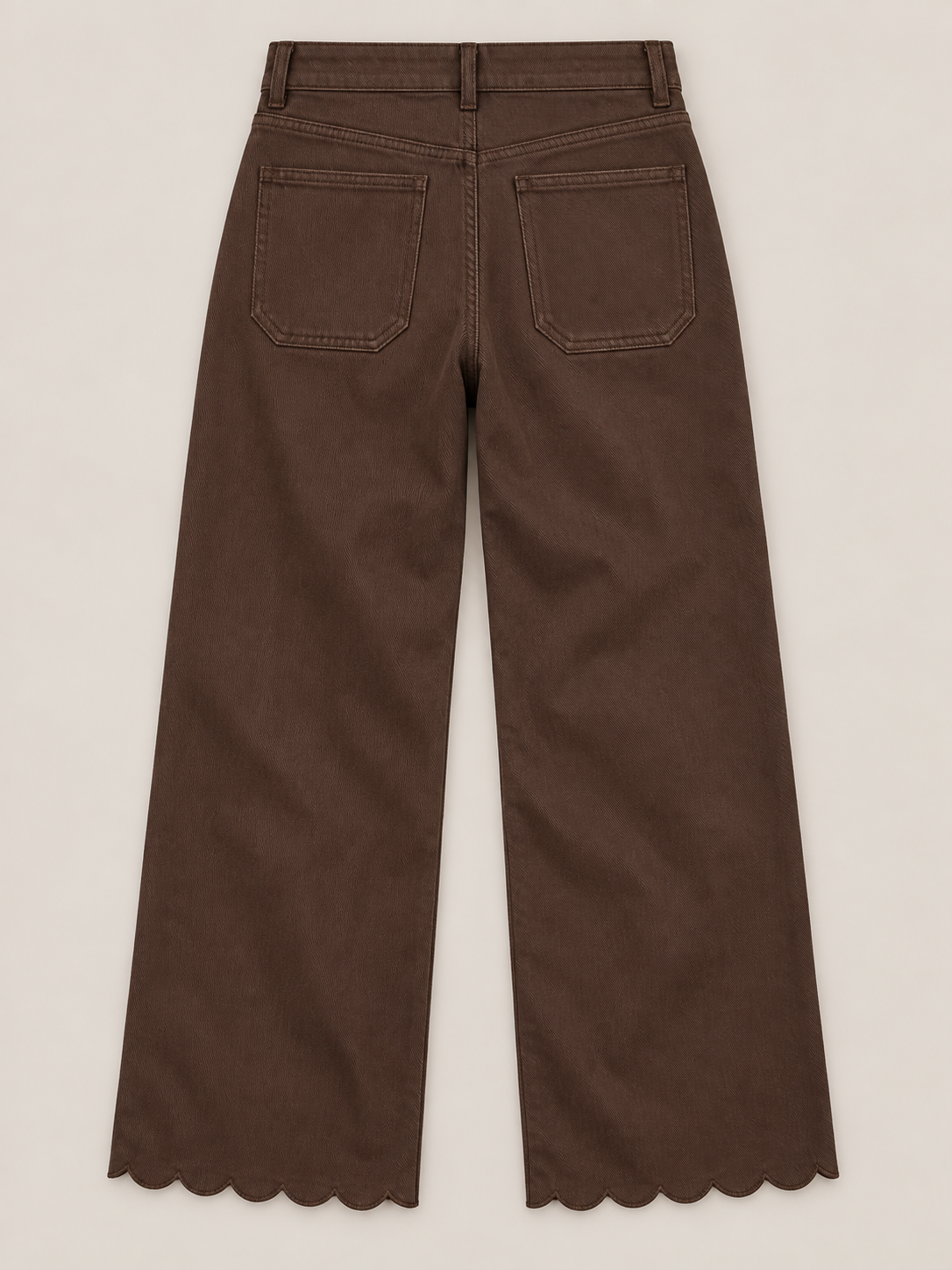 Brown jeans with a V-shaped rear yoke and scalloped hems, flat back view.