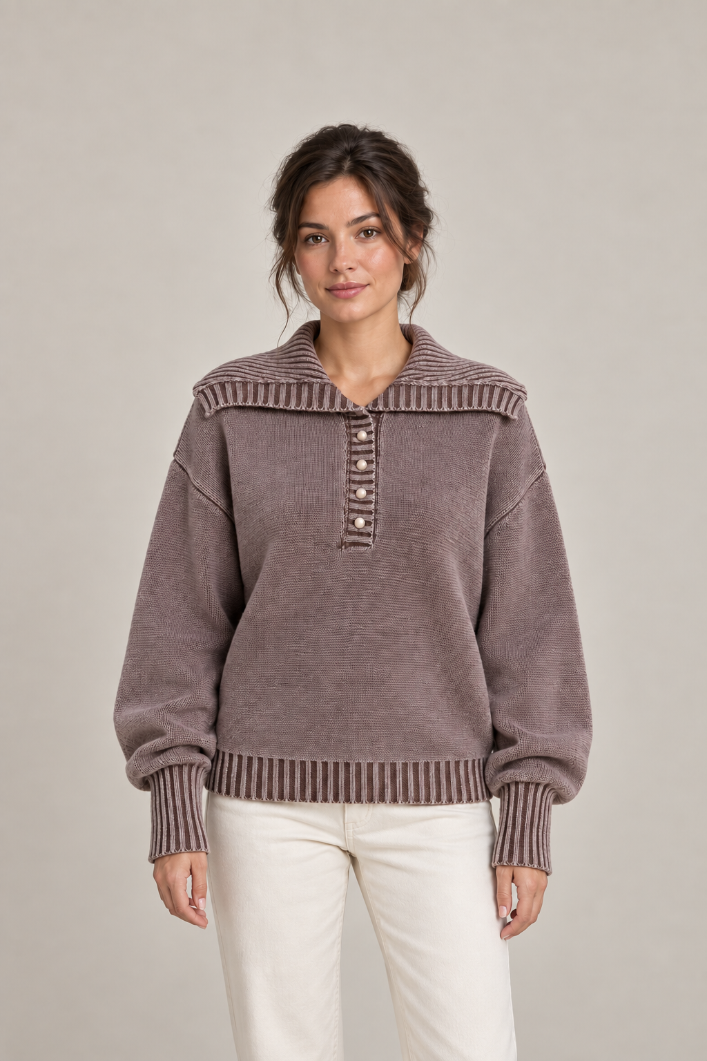 Brown washed cotton polo sweater on a model, front showing four-button placket and broad collar.