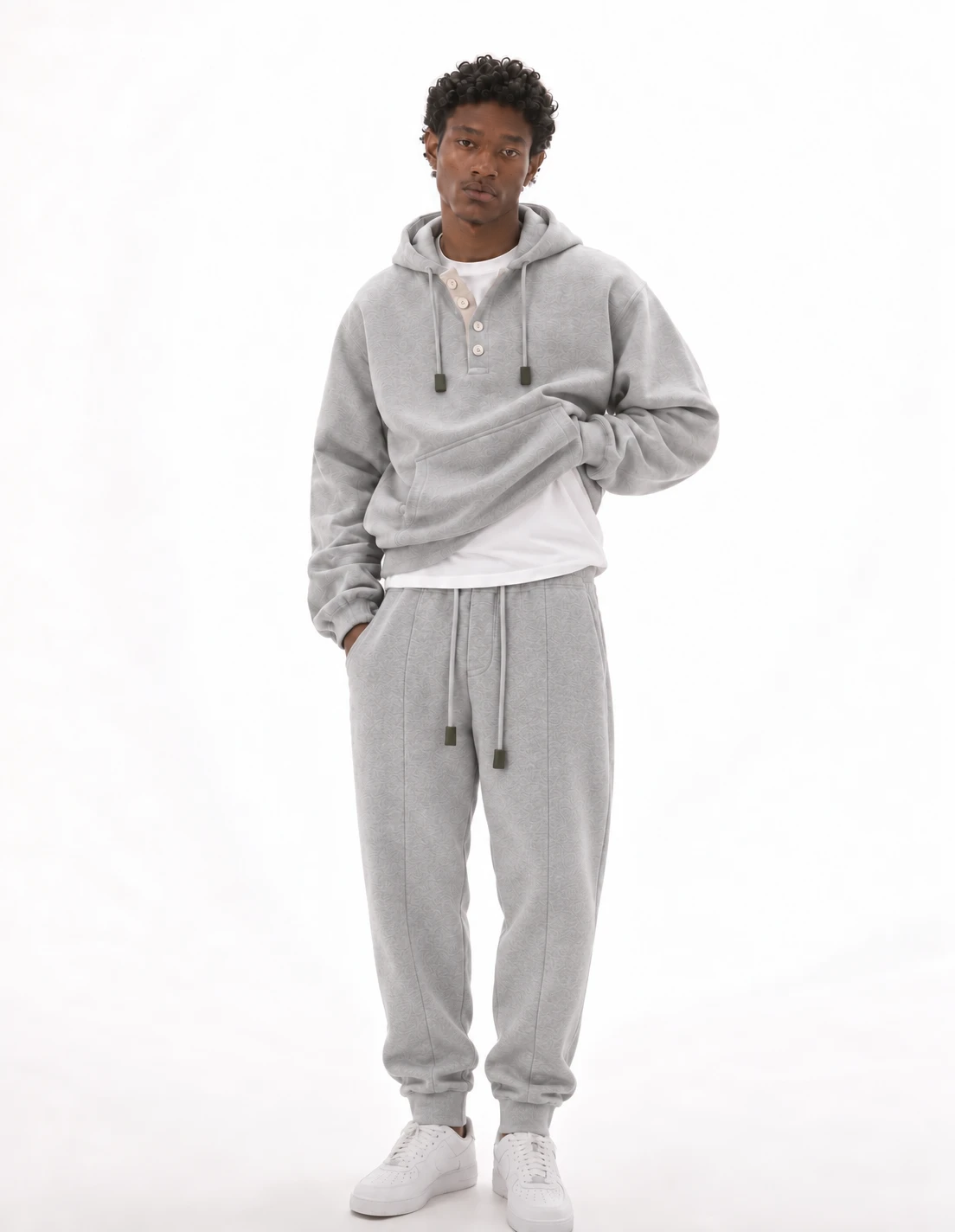 Model wearing the Mercer Henley Hoodie and Mercer Pleated Sweatpants in heather grey