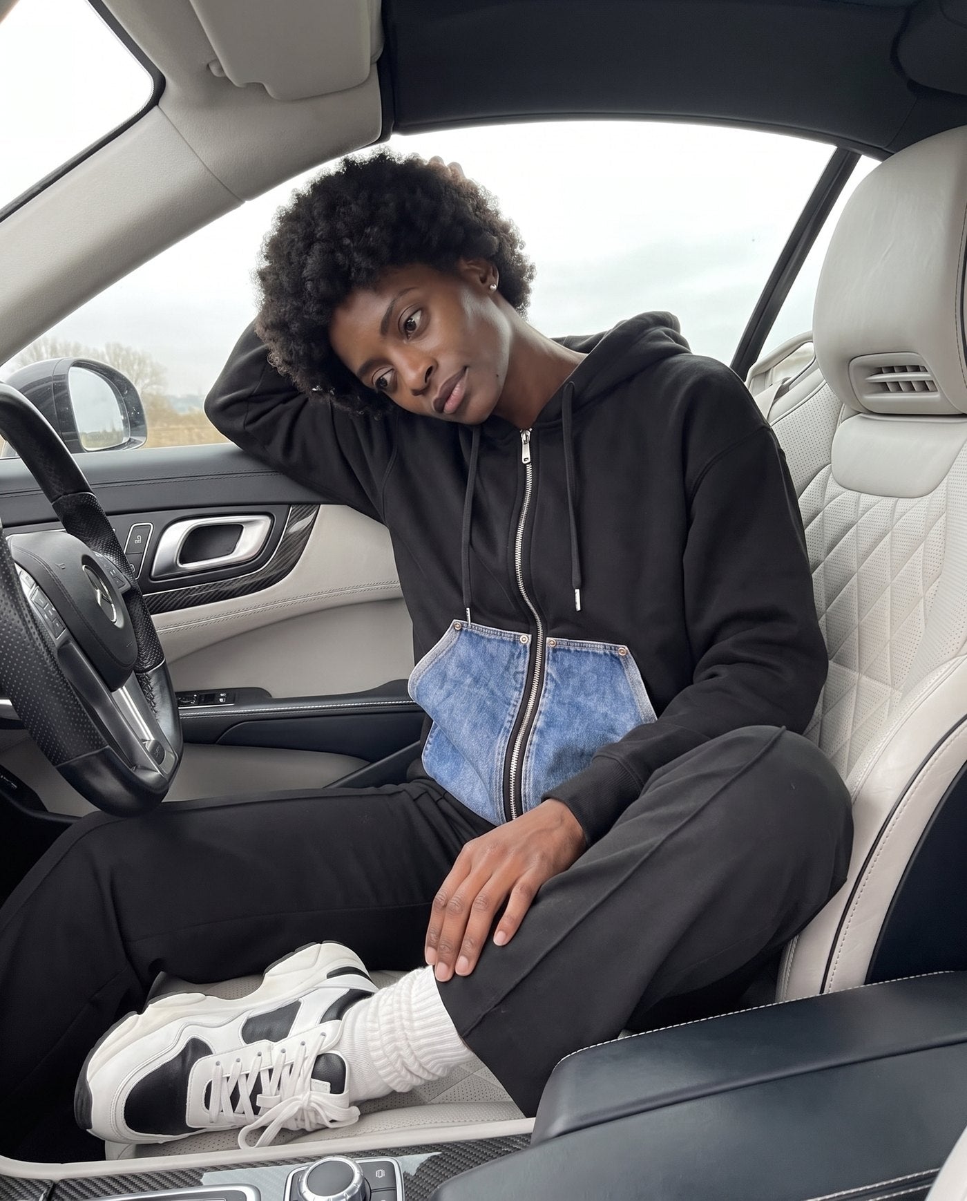 Camden denim pocket zip hoodie styled inside a car